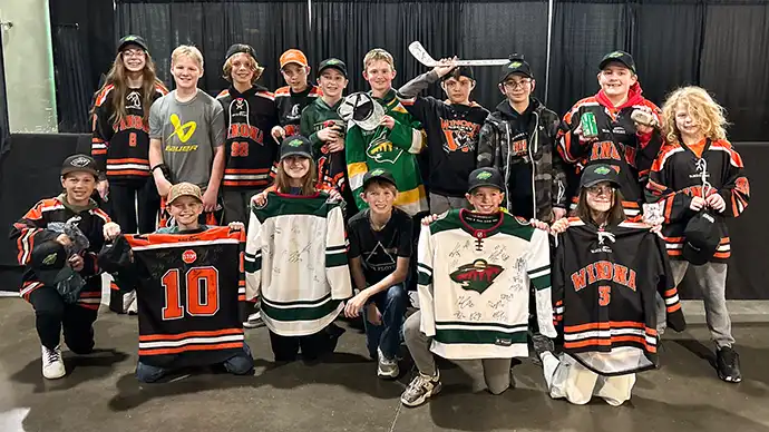Winona PeeWee C Team poses with autographed memorabilia 